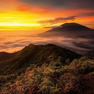 Scenic view of mountains against orange sky