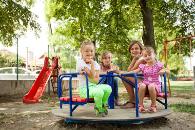 People sitting on slide at playground