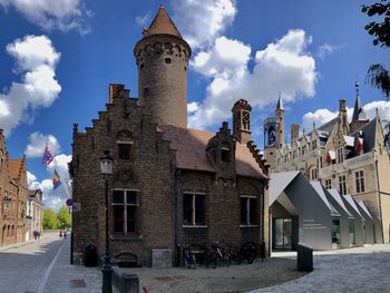 Buildings in town against sky