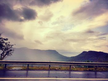 Scenic view of mountains against cloudy sky