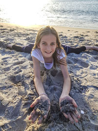 Portrait of smiling young woman on beach