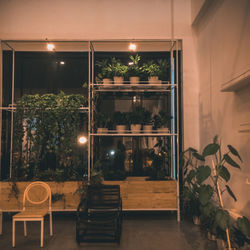 Empty chairs and tables in illuminated room