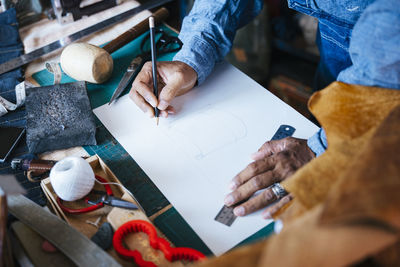 Midsection of people working in workshop