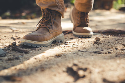 Low section of man standing on ground