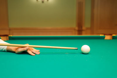 Cropped hand playing pool