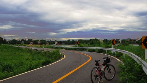 Bicycle on road against sky