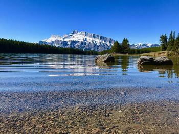 Scenic view of vermillion lakes with mt rundle in background during winter