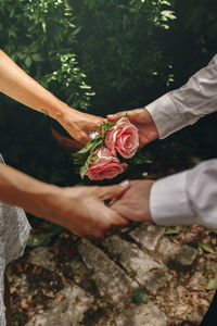 Midsection of woman holding rose bouquet