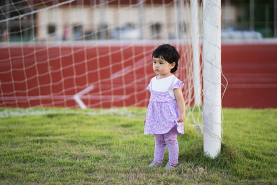 Full length of cute girl standing on grass