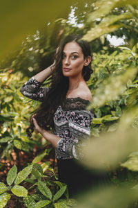 Portrait of young woman standing outdoors