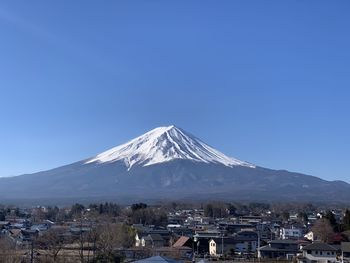 View of snowcapped mountain against blue sky