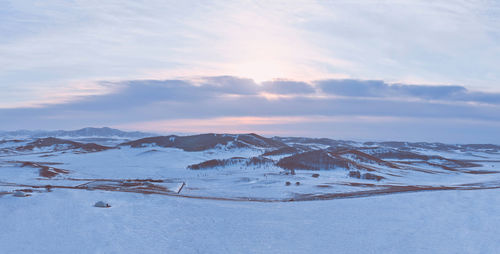 Scenic view of snow covered mountains against sky