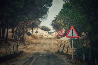 Road amidst trees against sky