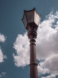 Low angle view of building against cloudy sky