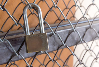 Close-up of padlock on chainlink fence