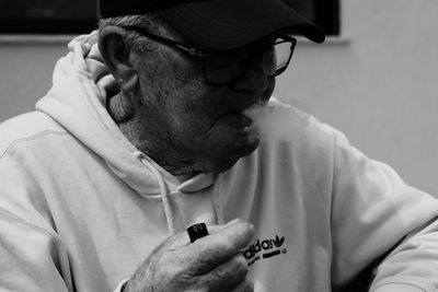 Midsection of man holding cigarette