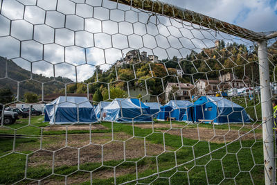 View of soccer field seen through chainlink fence