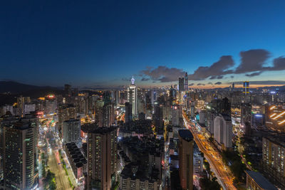 High angle view of illuminated city buildings at night