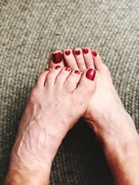 Low section of woman feet on hand