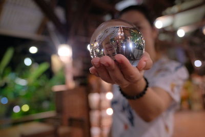 Close-up of woman holding crystal ball