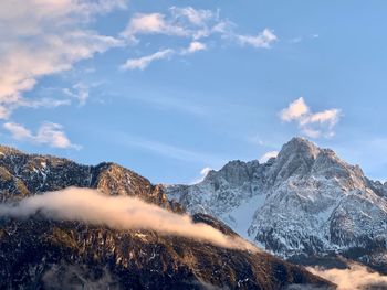 Scenic view of snow covered mountains against sky