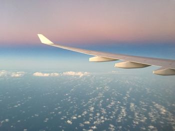 Cropped image of airplane flying over sea