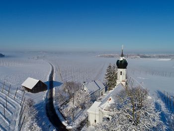 Scenic view of landscape against clear sky during winter