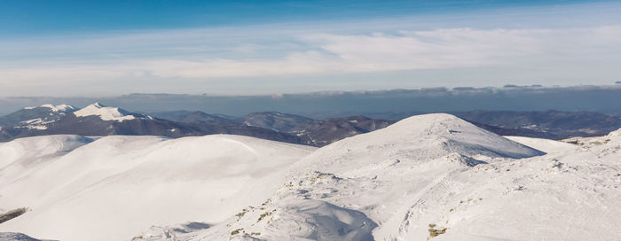 Scenic view of snowcapped mountains against sky