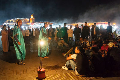 Group of people at illuminated temple at night