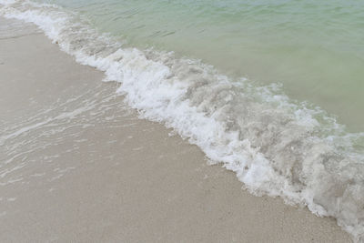 High angle view of waves rushing towards shore