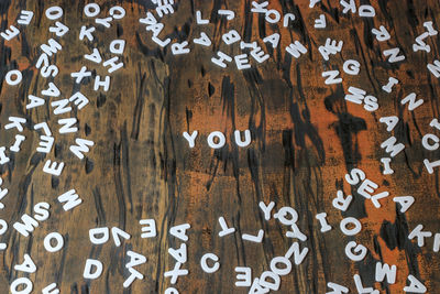 Full frame shot of alphabets on wooden table