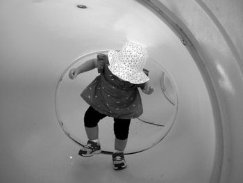 Girl playing with reflection in water