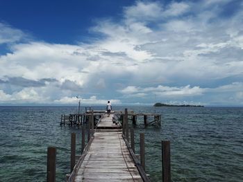 Pier over sea against sky