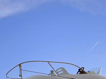 Low angle view of airplane against clear blue sky