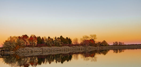 Scenic view of calm lake at sunset