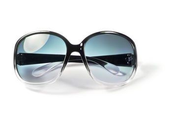 Close-up of sunglasses against white background