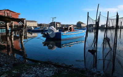 View of fishing boats moored in canal