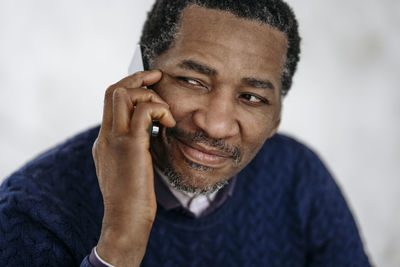 Smiling mature man talking on mobile phone
