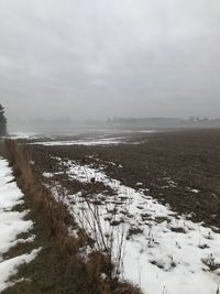 Scenic view of frozen landscape against sky