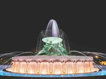 Close-up of cake against black background