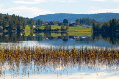 Scenic view of lake and mountains against sky