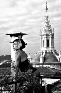 Portrait of woman outside temple against building