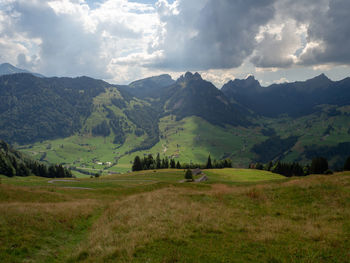 Scenic view of landscape and mountains against sky