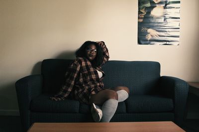 Young woman sitting at home