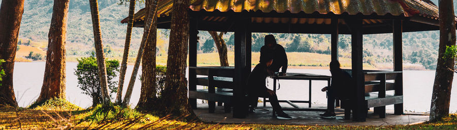 Rear view of man sitting on chair