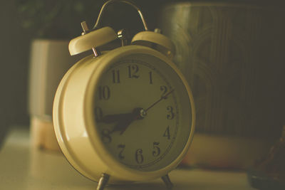 Close-up of alarm clock on table