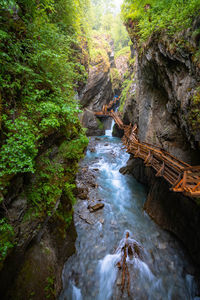 High angle view of river flowing through rocks