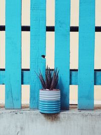 Blue metal fence against building