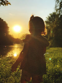 Little girl enjoy the summer sunset