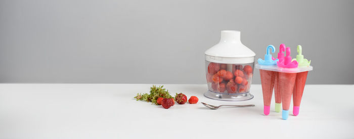 Close-up of glasses on table against white background